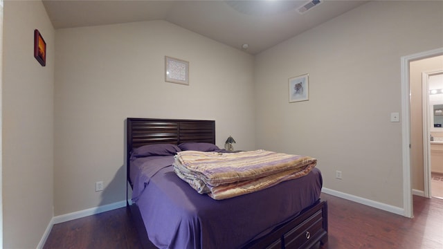 bedroom with vaulted ceiling and dark hardwood / wood-style floors