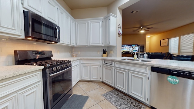 kitchen featuring stainless steel appliances, white cabinetry, sink, and light tile patterned floors