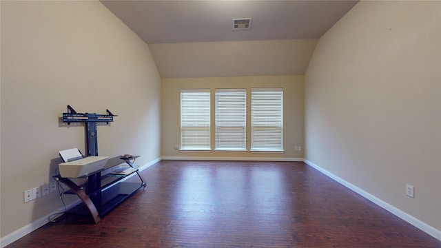 interior space featuring lofted ceiling and dark hardwood / wood-style floors