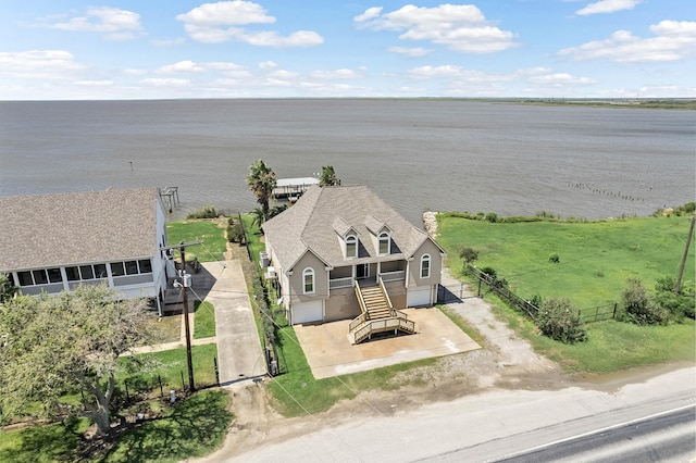 birds eye view of property with a water view