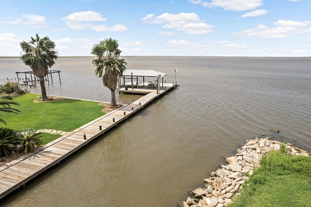 dock area with a water view and a yard