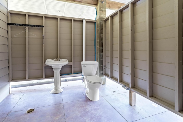 bathroom featuring toilet and concrete floors