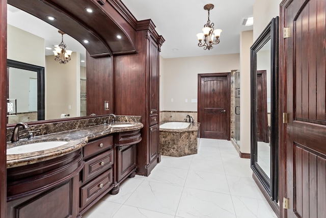 bathroom featuring vanity, independent shower and bath, and an inviting chandelier