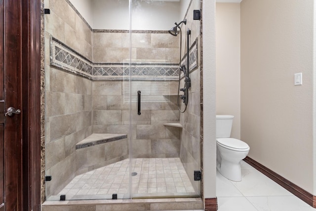 bathroom with toilet, tile patterned flooring, and walk in shower