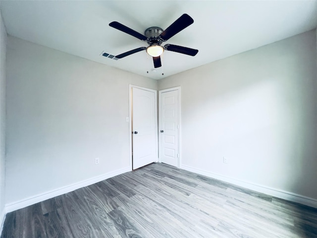 empty room featuring ceiling fan and hardwood / wood-style flooring