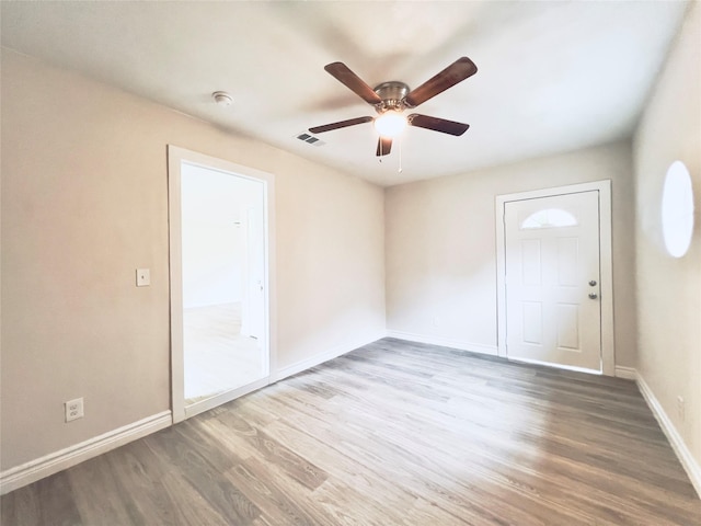 empty room with ceiling fan and wood-type flooring