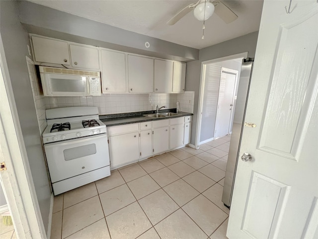 kitchen featuring decorative backsplash, sink, white cabinets, and white appliances