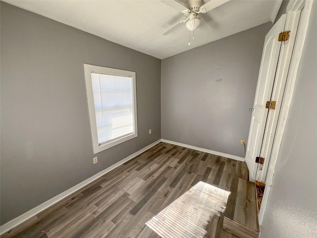 spare room with ceiling fan and dark hardwood / wood-style flooring