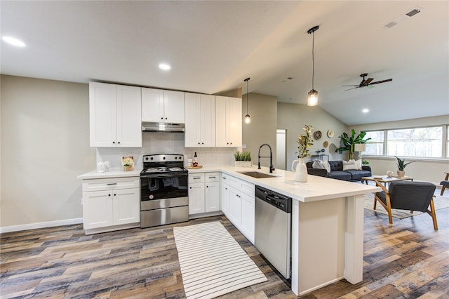 kitchen featuring pendant lighting, white cabinets, appliances with stainless steel finishes, sink, and kitchen peninsula