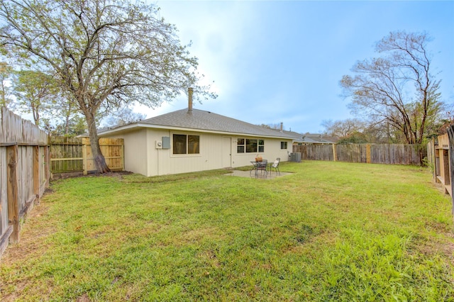 back of property with central AC, a lawn, and a patio