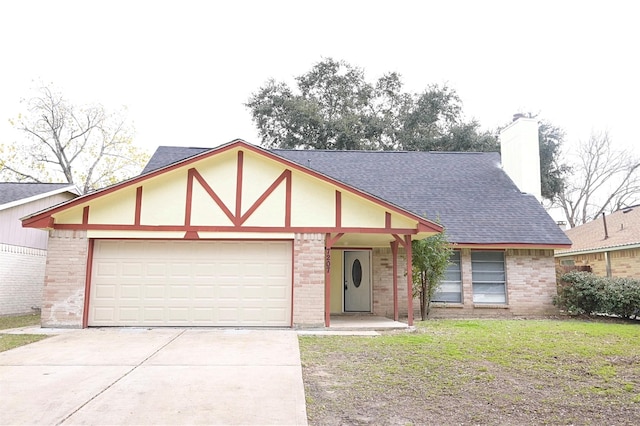 view of front of property featuring a garage and a front yard