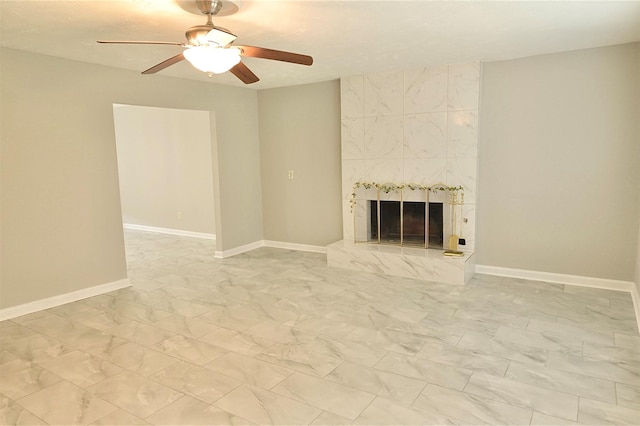 unfurnished living room featuring ceiling fan and a tile fireplace