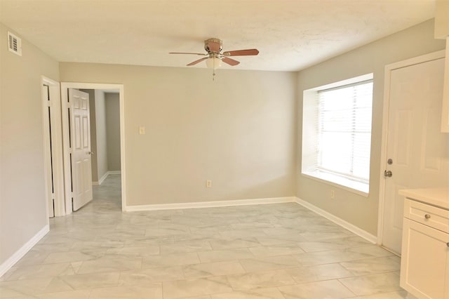 interior space with ceiling fan