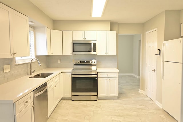 kitchen with sink, backsplash, white cabinets, and stainless steel appliances