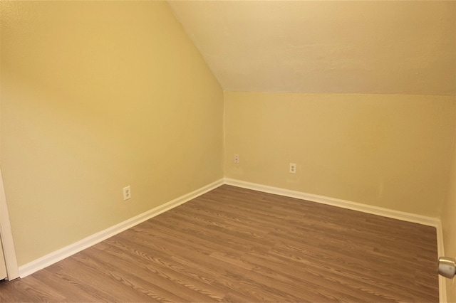 bonus room with wood-type flooring and vaulted ceiling