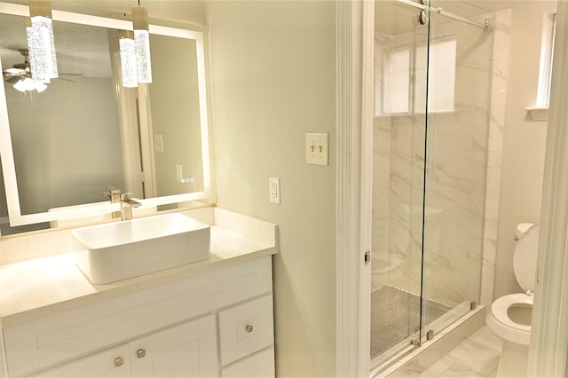 bathroom featuring toilet, a shower with shower door, ceiling fan, tile patterned flooring, and vanity