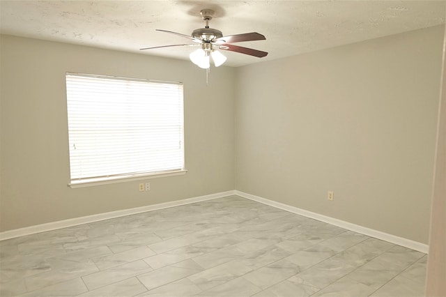 spare room with ceiling fan and a textured ceiling