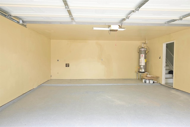 garage featuring water heater and a garage door opener