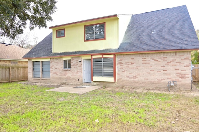 rear view of property with a patio and a yard