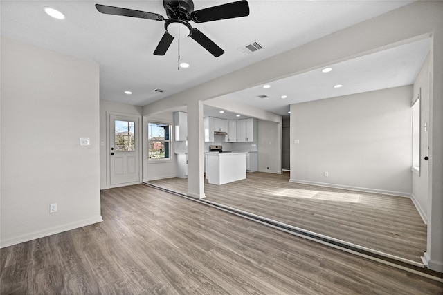 unfurnished living room featuring ceiling fan and wood-type flooring