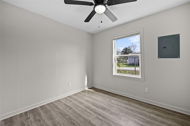 unfurnished room featuring ceiling fan, light hardwood / wood-style flooring, and electric panel