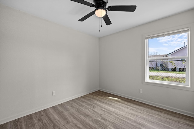 empty room featuring ceiling fan and light hardwood / wood-style flooring