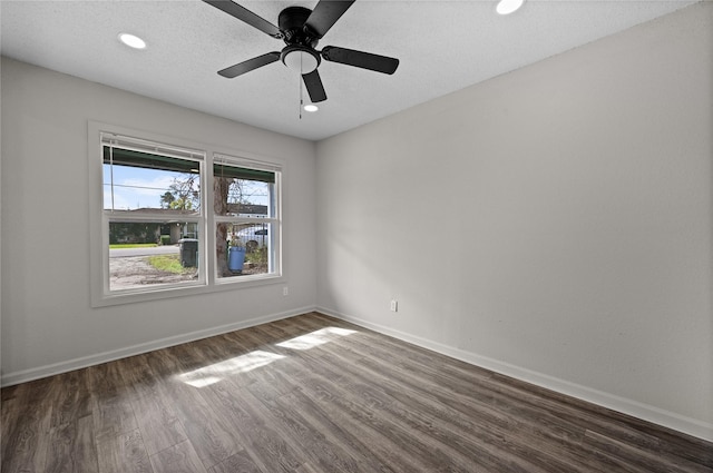 unfurnished room featuring ceiling fan and dark hardwood / wood-style flooring