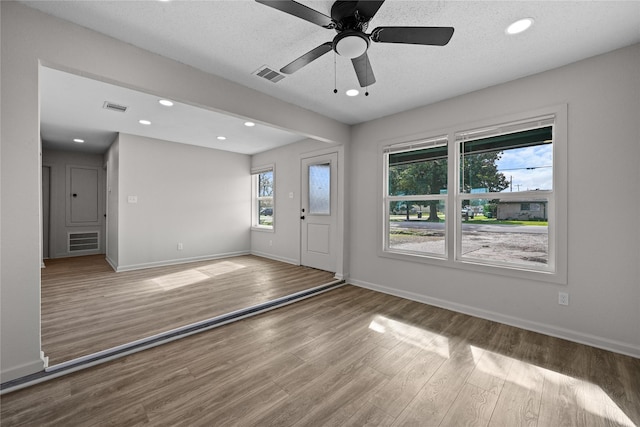 entrance foyer featuring ceiling fan, hardwood / wood-style floors, and a textured ceiling