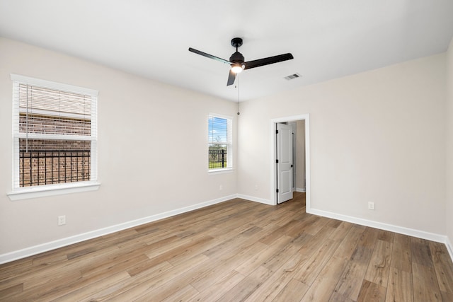 spare room featuring ceiling fan and light hardwood / wood-style flooring