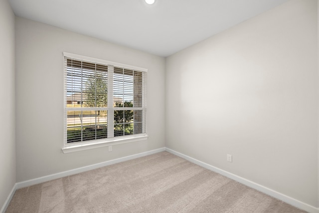 unfurnished room with light colored carpet