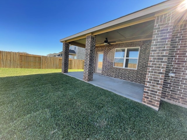 view of yard featuring a patio area and ceiling fan