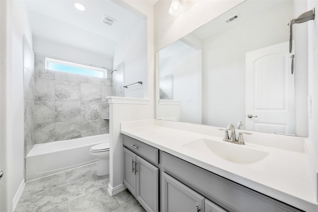 bathroom featuring visible vents, toilet, vanity, and shower / tub combination