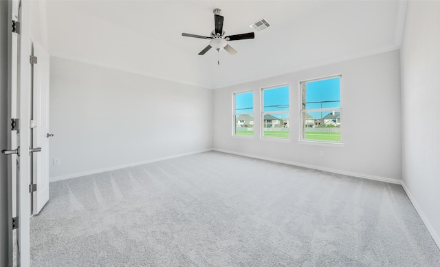 carpeted spare room featuring visible vents, baseboards, and a ceiling fan