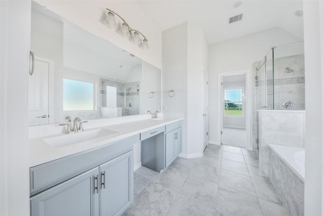 full bath with vaulted ceiling, visible vents, a healthy amount of sunlight, and a sink