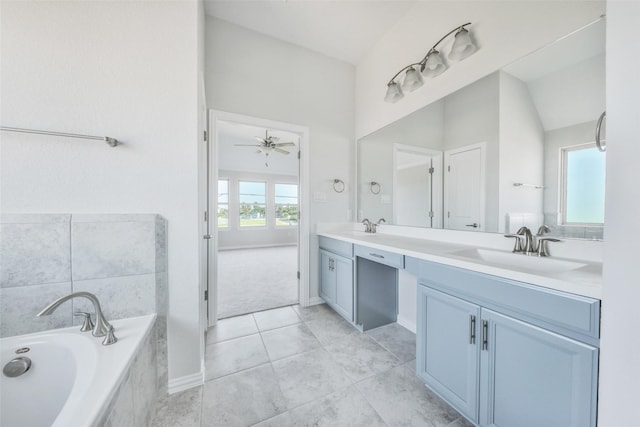 bathroom featuring ceiling fan, tile patterned floors, a relaxing tiled tub, and vanity