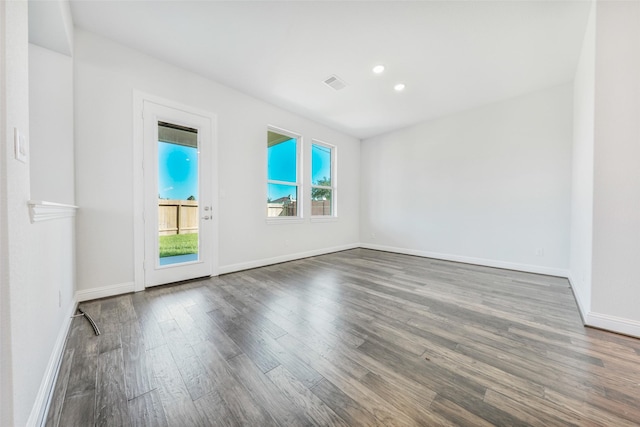 empty room with dark hardwood / wood-style flooring