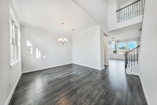 empty room with visible vents, dark wood-type flooring, baseboards, stairway, and ornamental molding