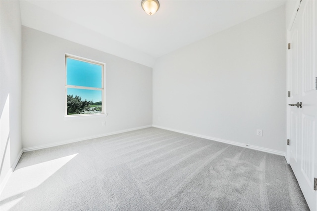 spare room featuring carpet flooring and baseboards