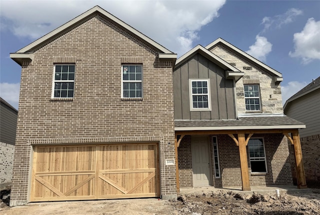 view of front facade with a garage, covered porch, board and batten siding, and brick siding