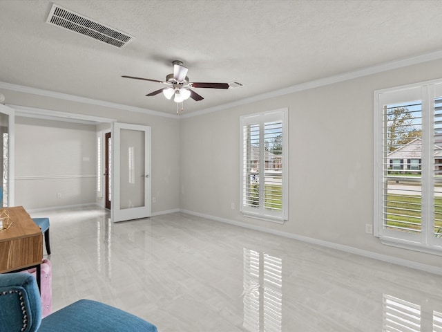 interior space with ceiling fan, french doors, ornamental molding, and a textured ceiling