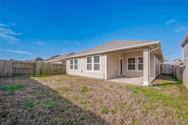 rear view of property with a patio area and a yard