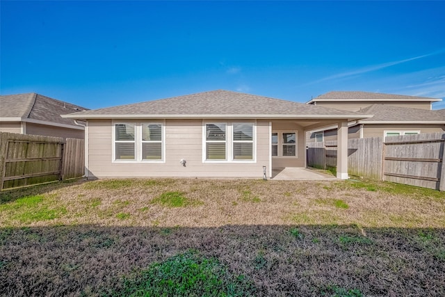 back of property with a patio area and a lawn