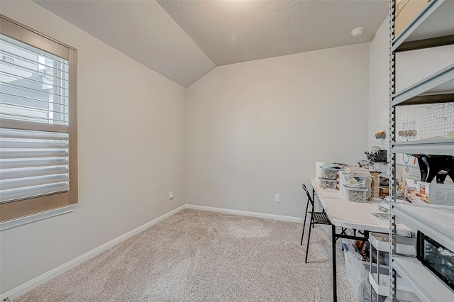 office with light colored carpet, a textured ceiling, and lofted ceiling