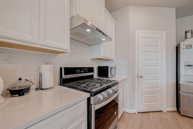 kitchen featuring extractor fan, decorative backsplash, light hardwood / wood-style flooring, stainless steel appliances, and white cabinets