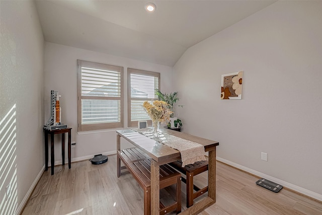 dining room with light hardwood / wood-style floors and lofted ceiling