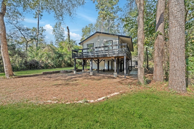 exterior space with a front lawn and a wooden deck