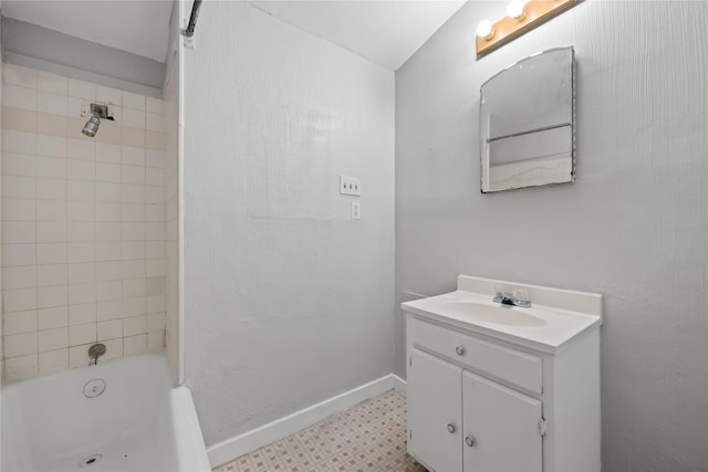 bathroom with vanity and tiled shower / bath