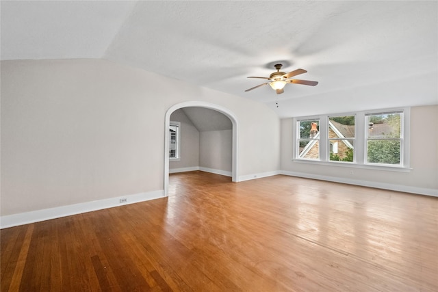 unfurnished living room featuring light hardwood / wood-style floors, lofted ceiling, and ceiling fan