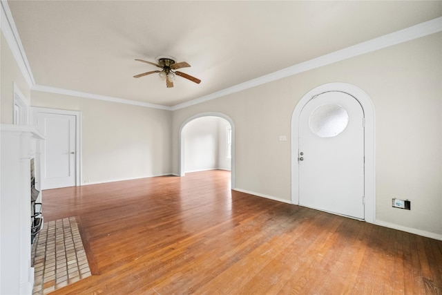 foyer with ceiling fan, crown molding, and hardwood / wood-style flooring