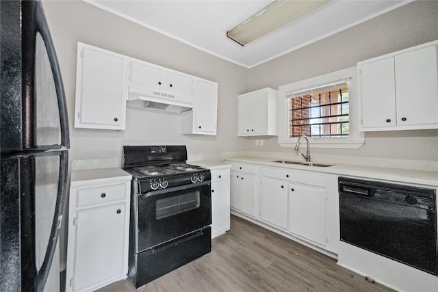 kitchen with sink, white cabinets, and black appliances